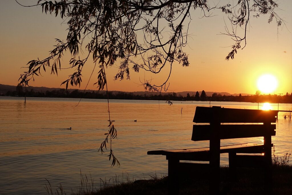 A bench sitting there with a sunset in the background.